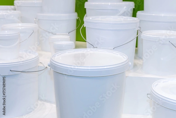 Fototapeta New white unmarked plastic round containers and buckets of various sizes designed for storing and transporting food and liquids