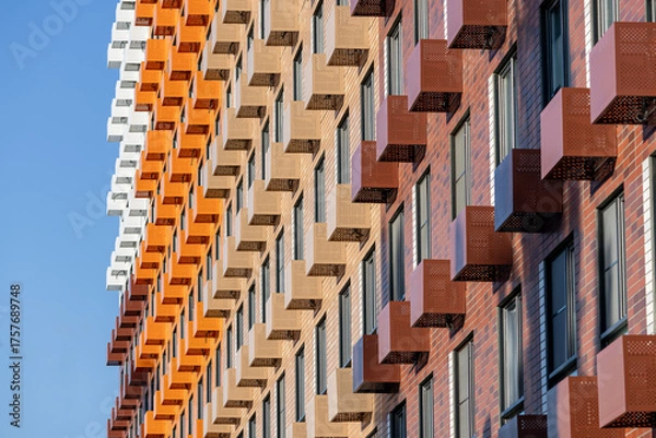 Obraz Baskets for placing outdoor air conditioner units on the facade of a new multi-story residential building. Climate control system in a residential building
