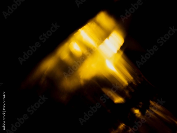 Obraz Yellow and orange light leaks on dark color background. Abstract light shape and form. Background for design and special effects.