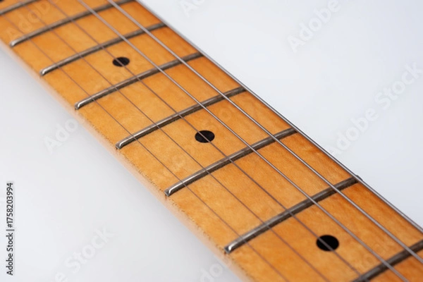 Fototapeta Six-string electric guitar, with a cream-colored wooden body and chrome-plated fittings.