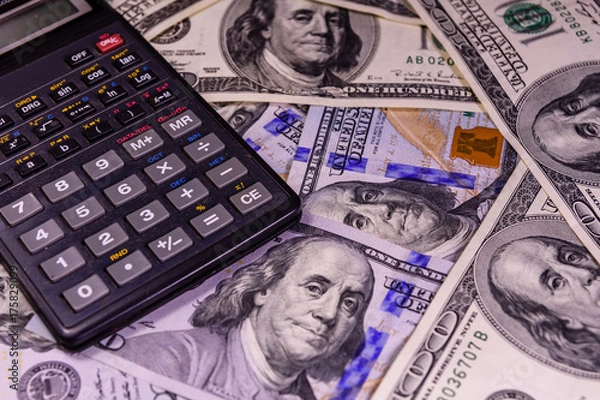 Fototapeta Modern calculator on a one hundred dollar bills