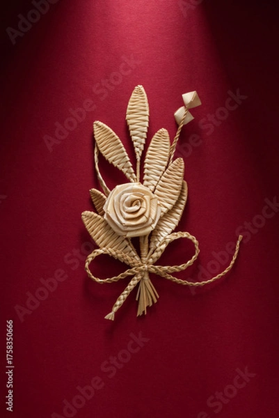Obraz Decoration of straw on a red background. Branch with flowers. Boutonniere made out of straw. Brooch. Straw weaving.