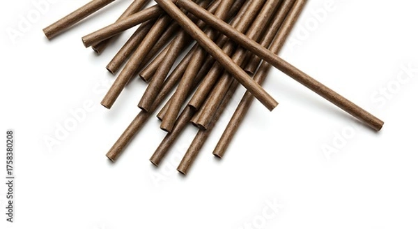 Obraz Close up of numerous brown cylindrical objects arranged on white background