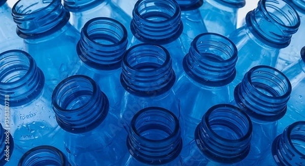 Obraz Close up of numerous clear plastic bottle openings against a blue background