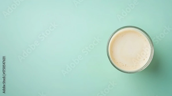 Fototapeta Creamy Beverage in Glass on Mint Green Background for Refreshing Drink Inspiration and Food Photography