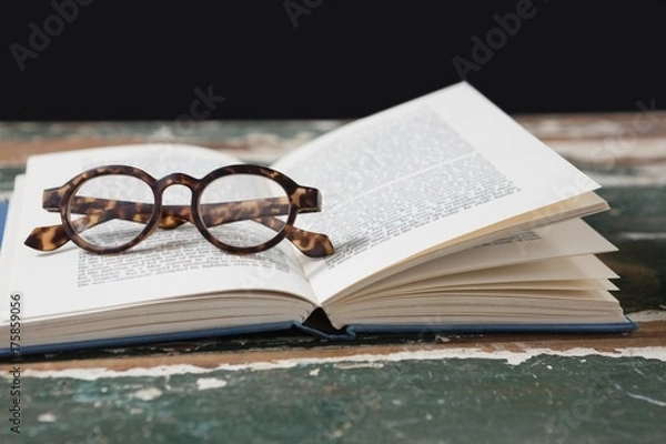 Fototapeta Spectacles on open book