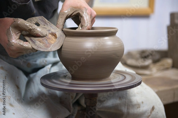 Obraz Hands of an artisan working on a potter's wheel