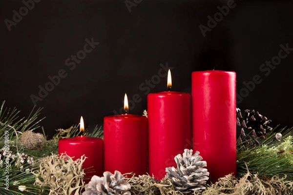 Fototapeta red advent candles with green pir and pinecone