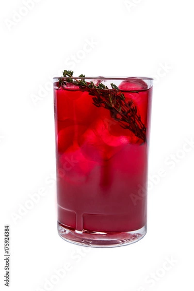 Fototapeta A red cocktail isolated in a highball with lots of ice cubes and rosemary as a decoration.