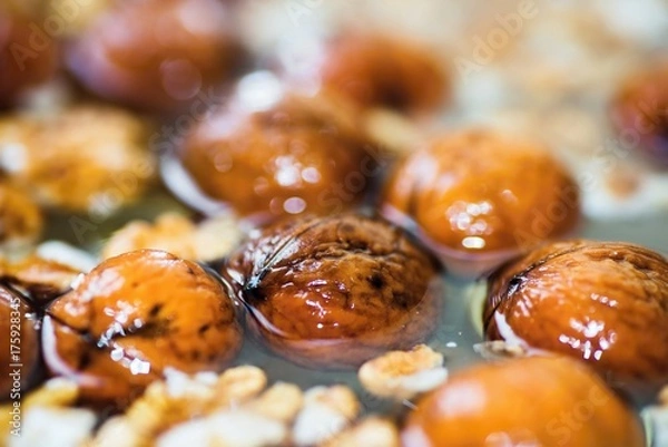 Fototapeta Whole walnut in water.