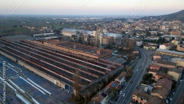 Fototapeta The former Fibronit factory is an abandoned industrial site where the production of products containing asbestos was carried out - asbestos factory remediated environmental remediation, Broni Lombardy