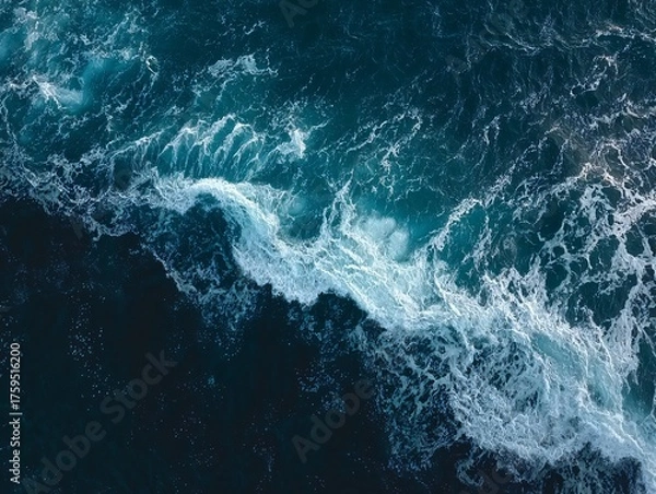 Fototapeta Aerial View of Turbulent Ocean Waves with Foamy White Crests Against Deep Blue Waters
