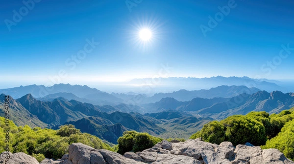 Fototapeta Breathtaking mountain landscape with sun shining over distant peaks, creating serene atmosphere