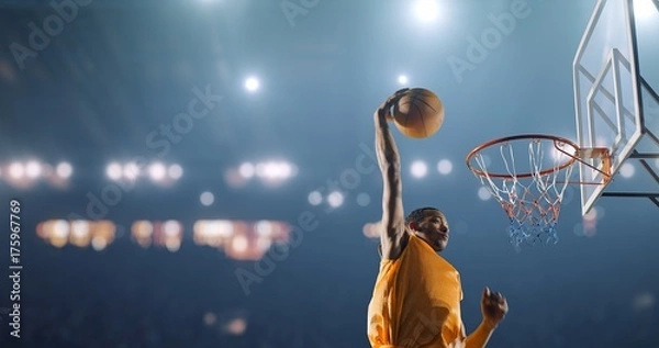Obraz Basketball player performs a slam dunk on a sport background