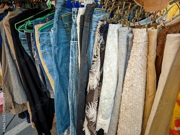 Fototapeta thrift store rack of used clothes and jeans