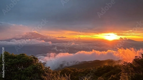 Obraz A breathtaking sunrise over a mountainous landscape, with golden sunlight piercing through the clouds and illuminating the peaks.
