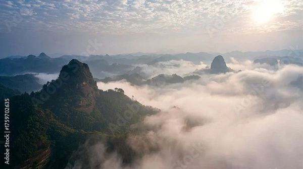 Obraz Majestic Mountain Peaks Emerging from a Sea of Clouds at Sunrise