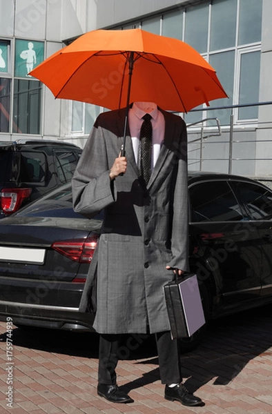 Obraz A headless man standing in a raincoat
