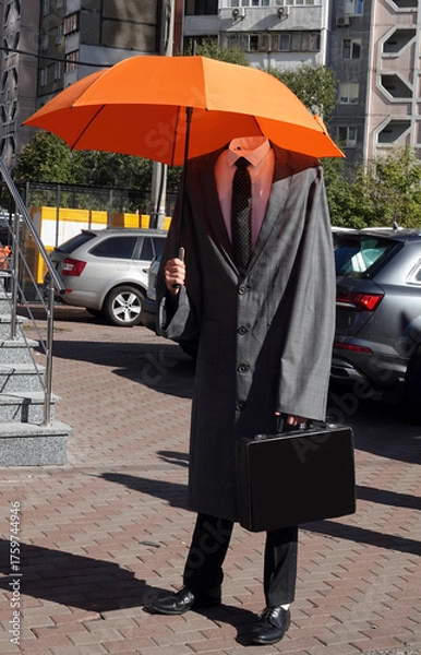 Obraz A headless man standing in a raincoat