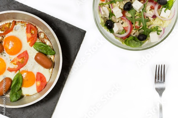 Fototapeta Fried eggs with sausages. Fresh salad and scrambled eggs. Healthy breakfast.