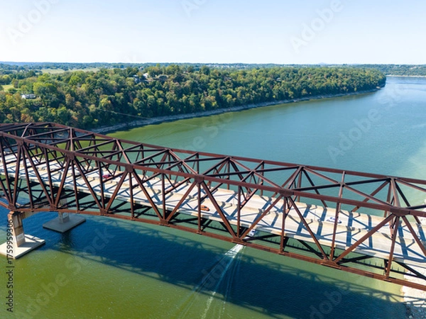 Fototapeta Aerial shot of rusty steel truss Bronston Bridge named The Houseboat Capital of the World Bridge spanning Cumberland River, with tree-lined banks and distant countryside