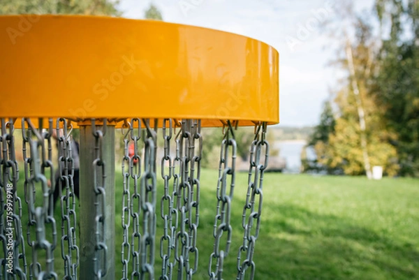 Fototapeta yellow discgolf basket on the course