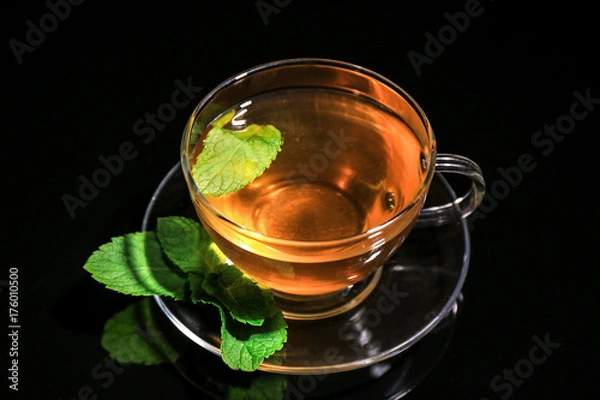 Fototapeta Cup of mint tea on black background