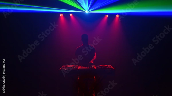 Obraz Male Disc jockey, DJ, silhouette with laser light