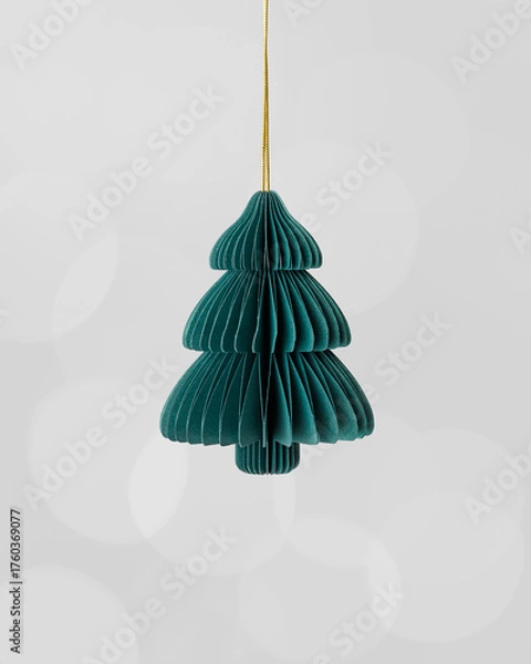 Fototapeta Minimal Christmas fir tree ornament of eco-friendly green paper hanging on golden string, on grey blurred bokeh background. Geometric shape stylish and natural look, holiday decoration trends.