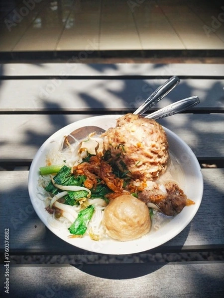 Fototapeta Close up of a jumbo meatballs with rice noodle soup, served with bean sprouts, green vegetables and pieces of beef cartilage