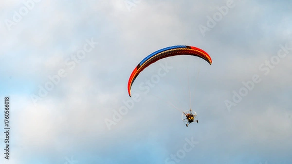 Obraz Man paragliding at sunset