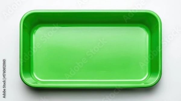Fototapeta Glossy, bright green rectangular plastic tray centered against a stark white background