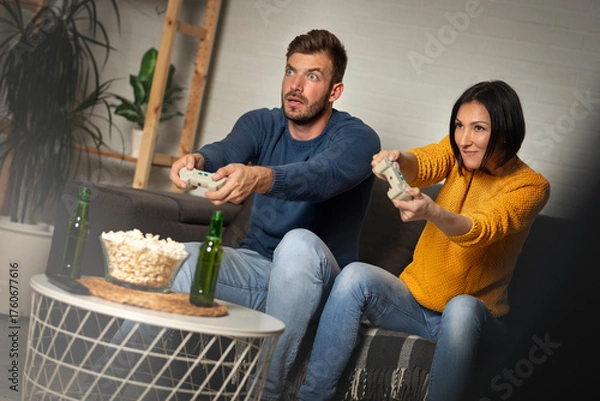 Obraz Young couple playing video games at home