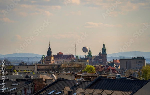 Fototapeta Historic Krakow skyline with iconic towers, rooftops, and distant hills under a clear sky. A perfect cityscape view of Poland's cultural heart.