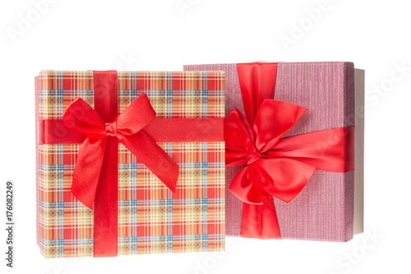 Fototapeta Gift boxes with red ribbons for Valentines day or Christmas, new year. Isolated on white