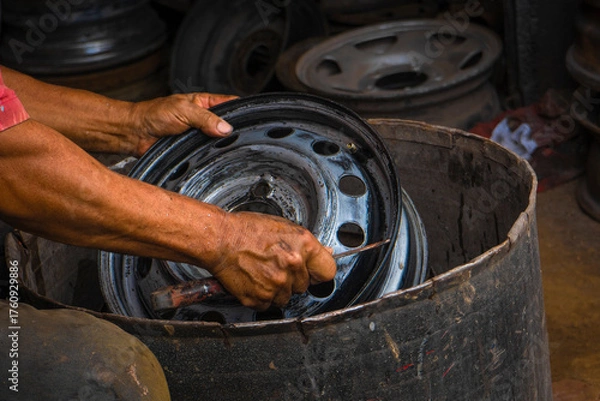 Obraz Mechanic working on the street fixing a car 