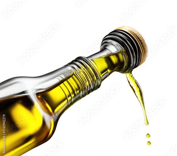 Fototapeta Close-up of golden liquid pouring from a clear glass bottle.  A metallic cap is visible