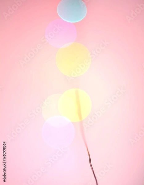 Fototapeta Abstract image of blurred, colorful circular lights against a pink background