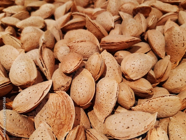 Obraz Organic fresh almonds at the market. Background of natural nuts. Healthy eating. Heap of almonds close up. Shelled almonds, full frame