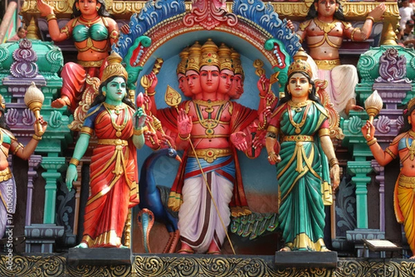 Obraz The six-headed Hindu god Kartikeya (Shanmukha) with spear and peacock as a colorful statue on temple exterior