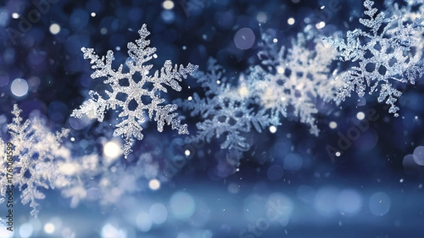 Fototapeta Blue background with frozen white snowflakes for Happy New Year and Christmas greetings.