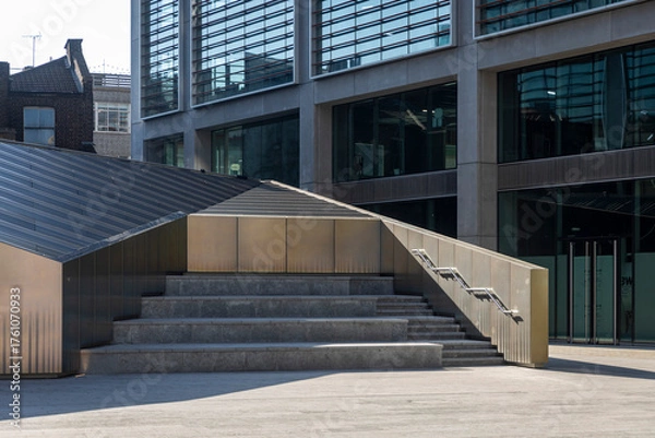 Fototapeta Modern geometric staircase and public space surrounded by new office buildings in London.