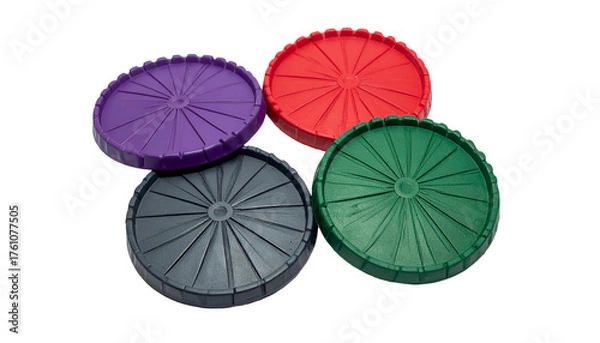Fototapeta Four colorful, ribbed, circular plastic components with central holes, against black