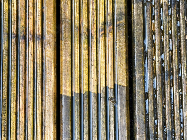 Obraz Before and after view of dirt and grime being cleaned from wooden decking using a pressure washer. DIY concept.