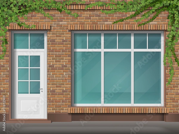 Fototapeta Store front with large transparent window. Facade of red brick. Empty glass showcase of boutique. Entrance in the small  shop.
