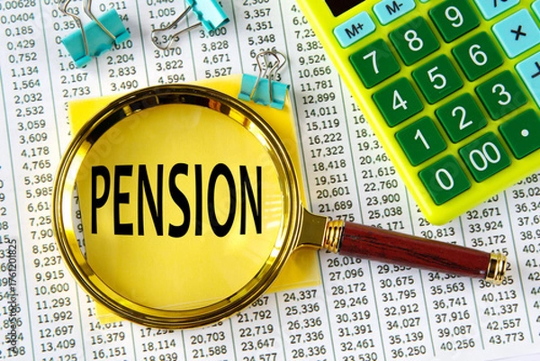 Fototapeta PENSION - word under a magnifying glass on the background of a calculator and a sheet with numbers