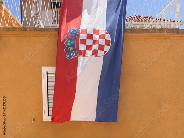 Obraz large Croatian flag hanging on side of building facade outdoors in Croatia