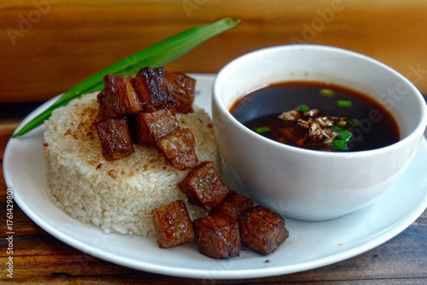 Fototapeta Grilled pork is served with fragrant fried rice, and a thick hot sauce is used for dressing. A classic Filipino dish filled with savory flavors.