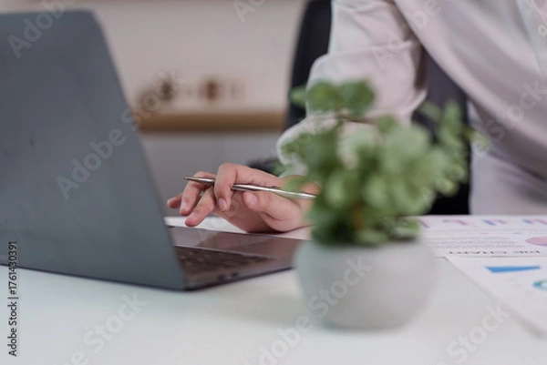 Fototapeta Digital Workspace. Professional using laptop for data analysis and reporting.