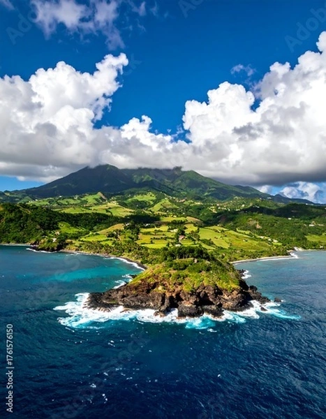 Obraz Aerial view of a lush island peninsula jutting into the ocean. Mountains rise in the background under a blue sky with clouds